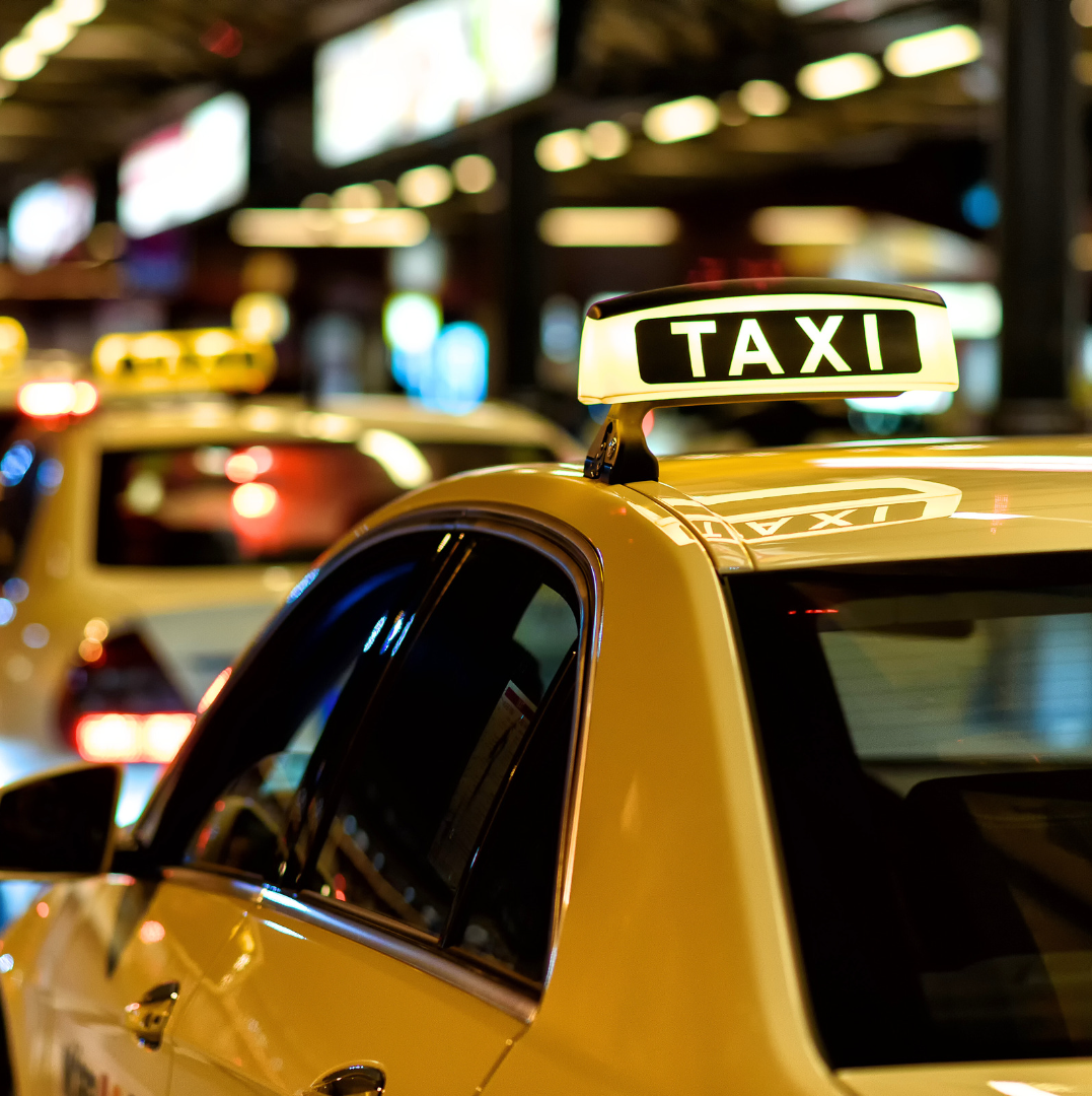 Close up of taxi cabs driving in traffic